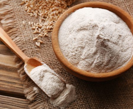 Flour in bowl with grains in bag on sackcloth background Flour in bowl with grains in bag on sackcloth background