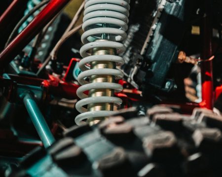 pexels-photo-5542145-5542145 Detailed view of an ATV's coil spring suspension highlighting mechanical design and rugged build.
